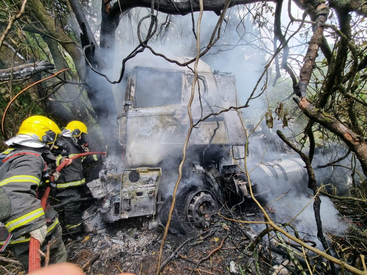 carreta-pega-fogo-apos-desviar-de-carro-que-fazia-ultrapassagem,-descer-barranco-e-bater-em-arvore-na-br-265